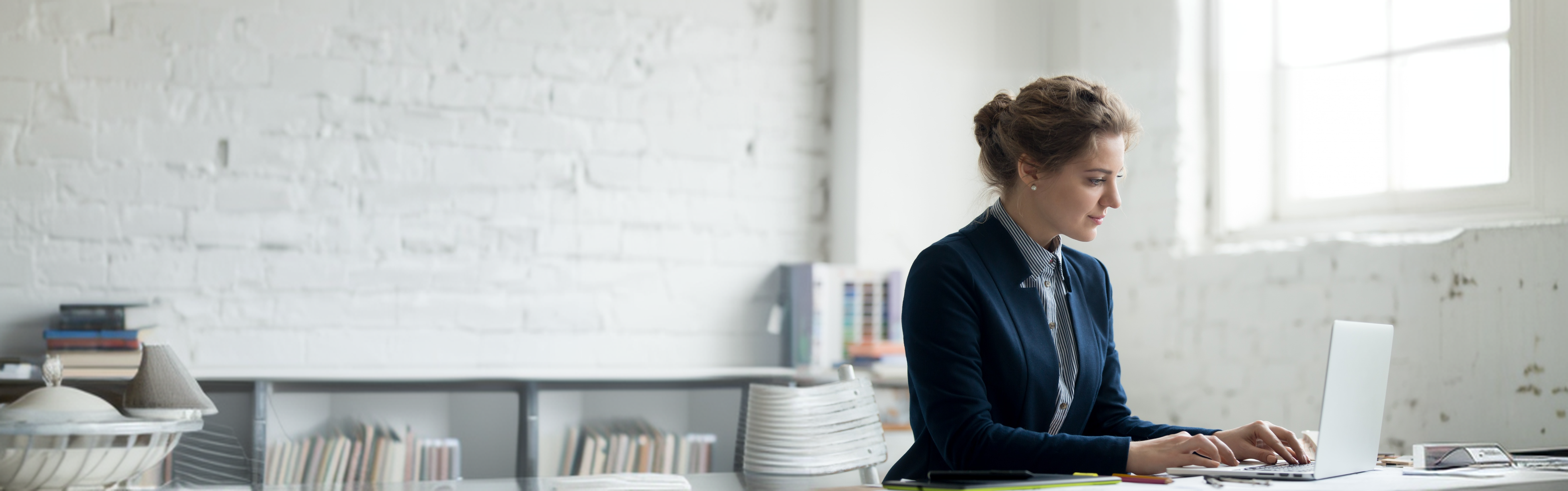 A publishing consultant working on a laptop